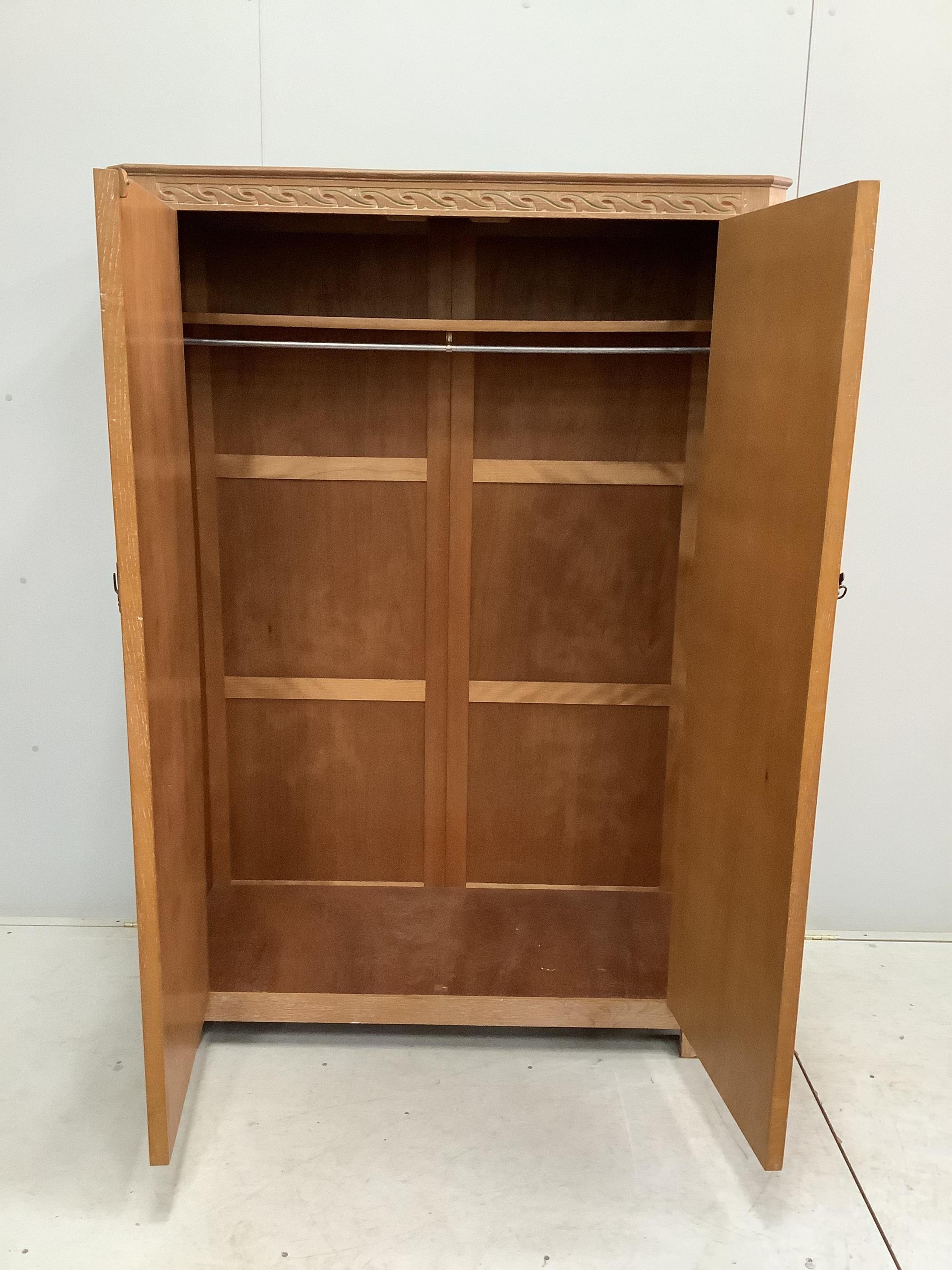 A painted limed oak eight piece bedroom suite, comprising a pair of three drawer chests, pair of bedside cabinets, dressing table stool, wardrobe and headboard. Condition - fair